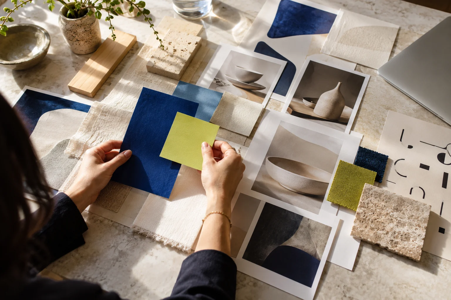 Illustrative designer arranging colour, paper and material samples for a brand